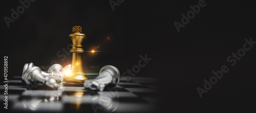 Wide banner. golden king with silver chess piece on chess board game competition with copy space on dark background, chess battle, victory, success, team leader, teamwork, business strategy concept