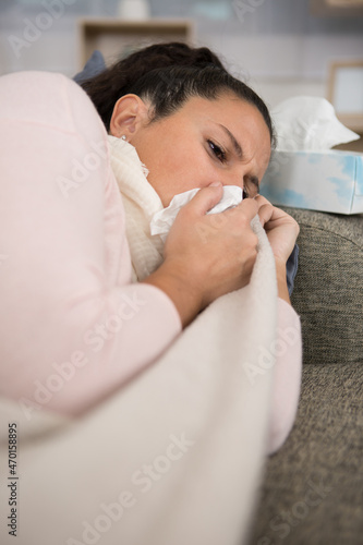 ill woman suffering alone on the sofa