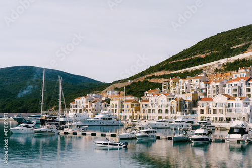 Luxury yachts are moored in a row at the Lustica Bay marina. Montenegro © Nadtochiy