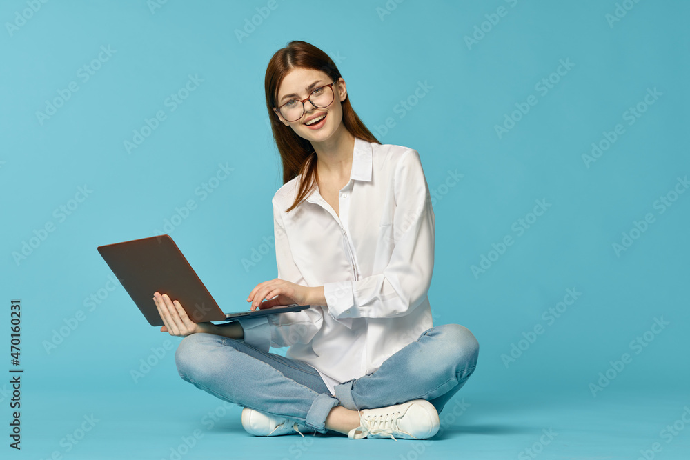 woman with laptop sitting on the floor learning student technology blue background woman with laptop sitting on the floor learning student technology blue background