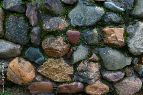 Texture, background of a wall made of moss and stones