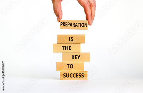 Preparation and success symbol. Wooden blocks with words Preparation is the key to success on on a beautiful white background, copy space. Businessman hand. Business, preparation and success concept. photo