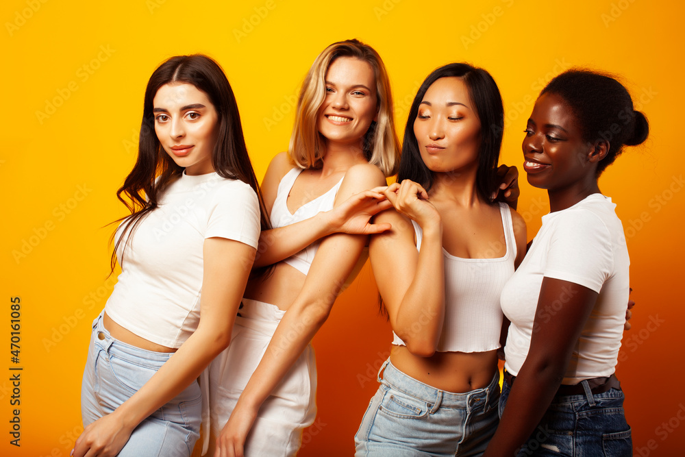 diverse multi nation girls group, teenage friends company cheerful having fun, happy smiling, cute posing on yellow background, lifestyle people concept, african-american, asian and caucasian diverse multi nation girls group, teenage friends company cheerful having fun, happy smiling, cute posing on yellow background, lifestyle people concept, african-american, asian and caucasian