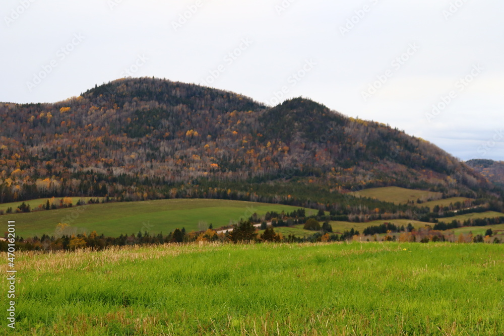Charlevoix landscape in autumn. Field and mountains in october. Rural and countryside in autumn. Autumnal. Travel in Charlevoix in Quebec.