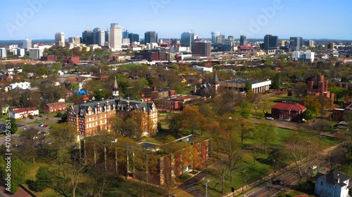 Aerial tracking shot of Fisk University featuring Jubilee Hall and the city skyline in Nashville Tennessee photo