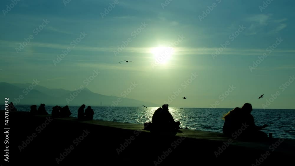 People Silhouette near the Seaside in Sunset People Silhouette near the Seaside in Sunset