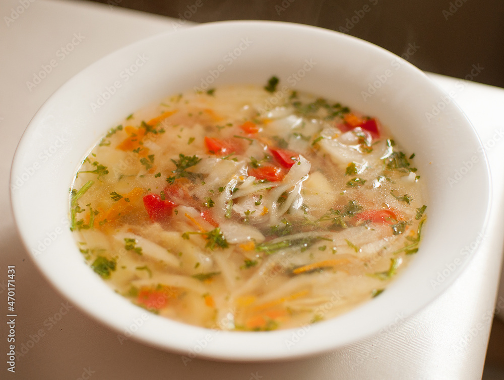 soup with cabbage in a white plate