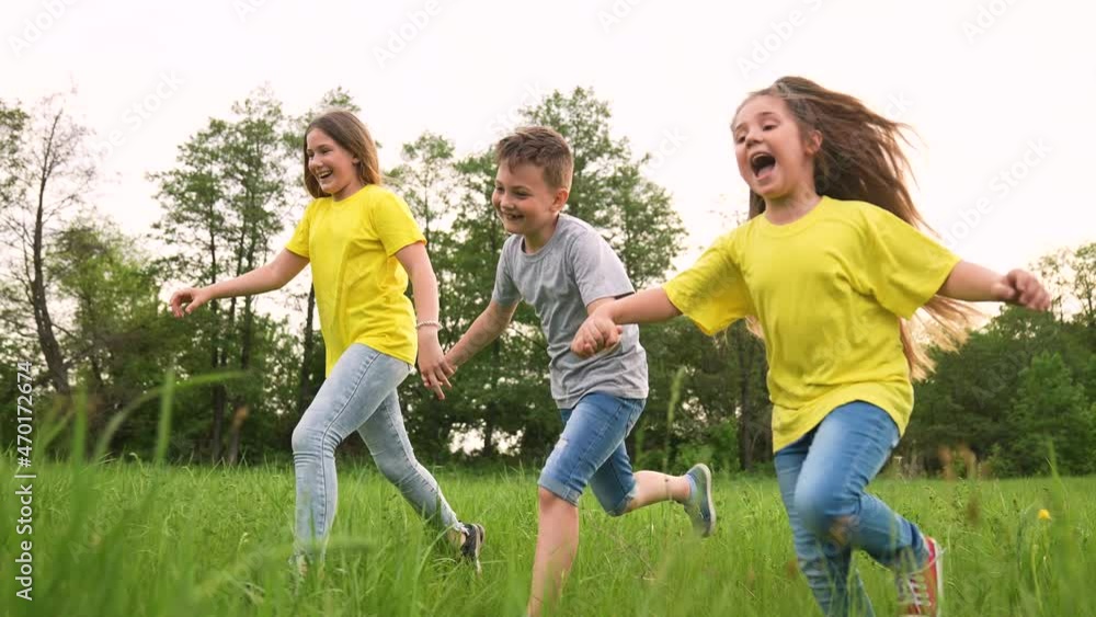 Young team of children. Group of children run in park on grass. Team play in park. Teamwork concept Children run on green grass. Kids team run in park. Kids play in natural park.Group of kids teamwork Young team of children. Group of children run in park on grass. Team play in park. Teamwork concept Children run on green grass. Kids team run in park. Kids play in natural park.Group of kids teamwork