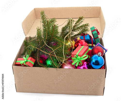 Christmas toys with a Christmas tree branch in a box.