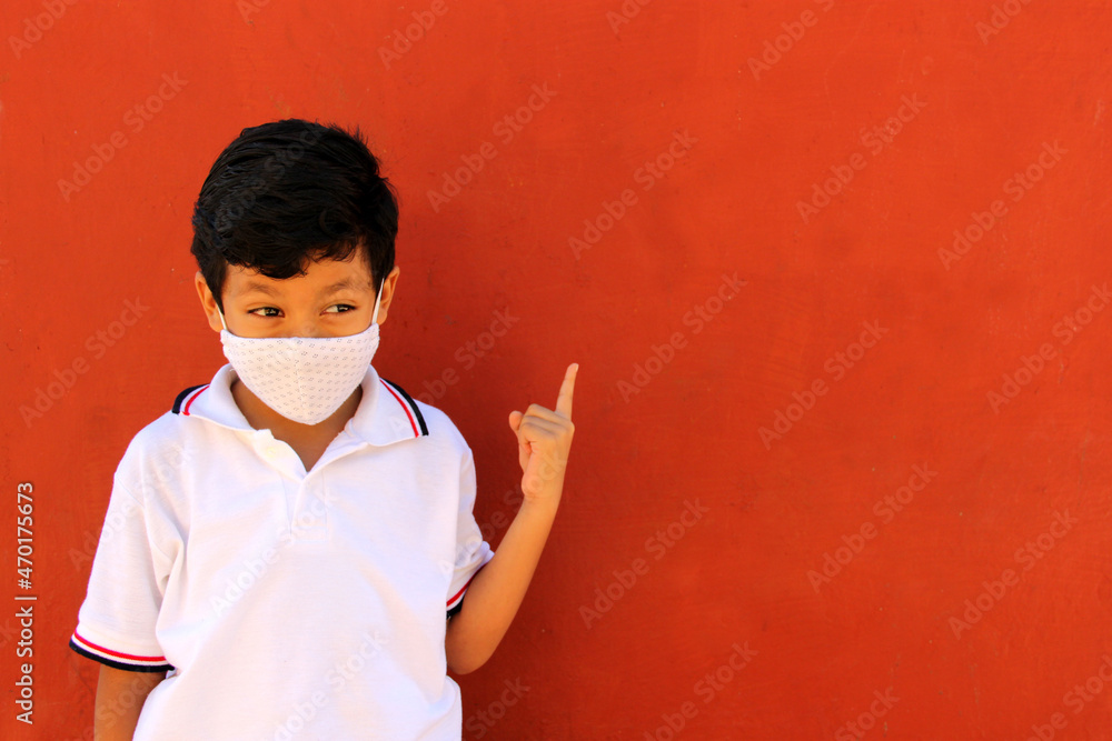 Latino boy with mask and school uniform shirt is happy to return to school in the new normal due to the coronavirus pandemic
Latino boy with mask and school uniform shirt is happy to return to school in the new normal due to the coronavirus pandemic