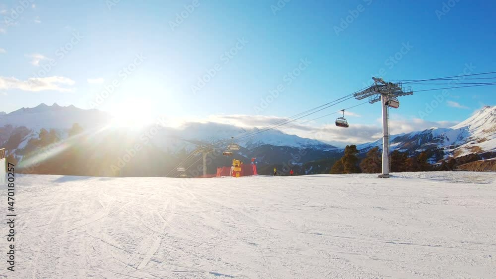 Ski lift in mountain resort. Ski resort chairlift gondola on steep mountain ski slopes. Ski lift in mountain resort. Ski resort chairlift gondola on steep mountain ski slopes.