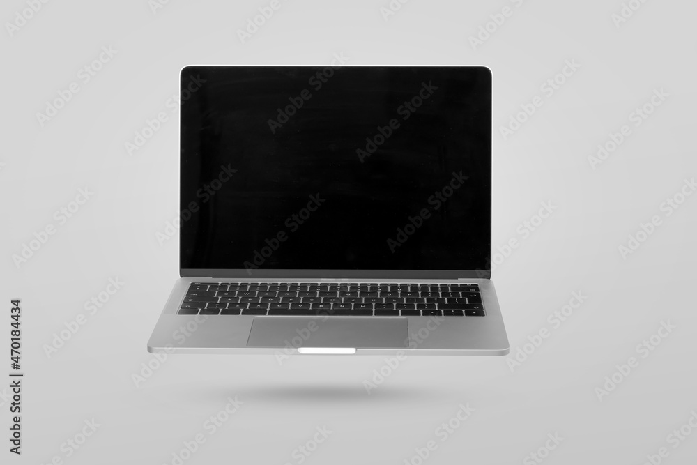 Laptop computer with empty screen levitating in the air on a gray background. Creative minimal background. Laptop computer with empty screen levitating in the air on a gray background. Creative minimal background.
