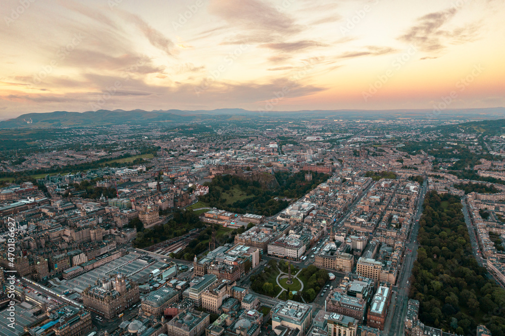 Aerial view of Edinburgh cityscape as sun rises over the city. Old city wakes up with the sunrise. Early morning haze lifts as the first rays of sunlight hit the city of Edinburgh, Scotland