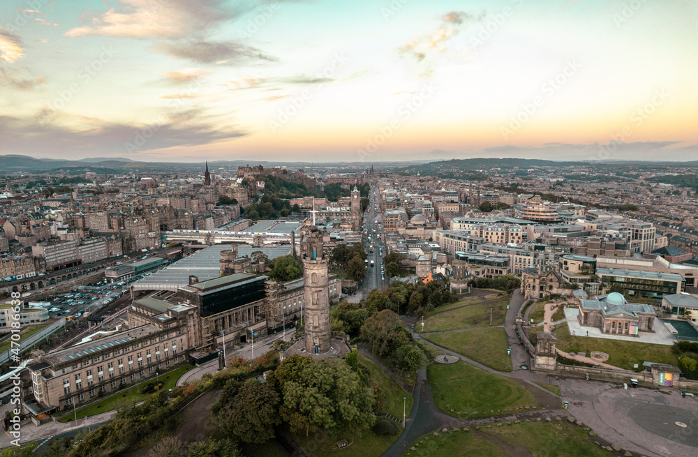 Fototapeta premium Aerial sunrise view of Nelson Monument in Calton Hill, Edinburgh, Scotland. Large monument to a famous military leader. When it was built, the Nelson Monument was the tallest structure in the world