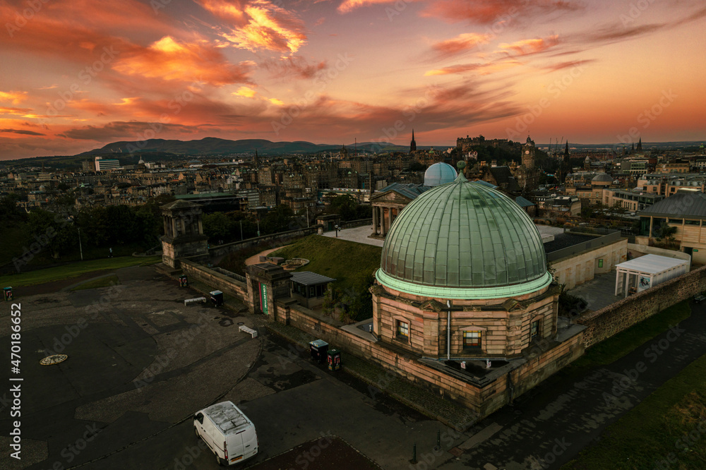 Aerial sunrise view of Calton Hill in Edinburgh, Scotland surrounded by old buildings. Locals use the hill to observe the vastness of the city, enjoy festivals, or attend to spiritual activities Aerial sunrise view of Calton Hill in Edinburgh, Scotland surrounded by old buildings. Locals use the hill to observe the vastness of the city, enjoy festivals, or attend to spiritual activities