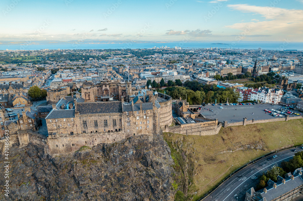 Aerial view of Edinburgh Castle, a royal castle occupying a commanding position atop a volcanic crag with cliffs on three sides and the fourth side facing the capital city of Edinburgh