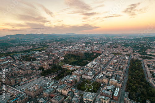 Aerial view of Edinburgh cityscape as sun rises over the city. Old city wakes up with the sunrise. Early morning haze lifts as the first rays of sunlight hit the city of Edinburgh, Scotland