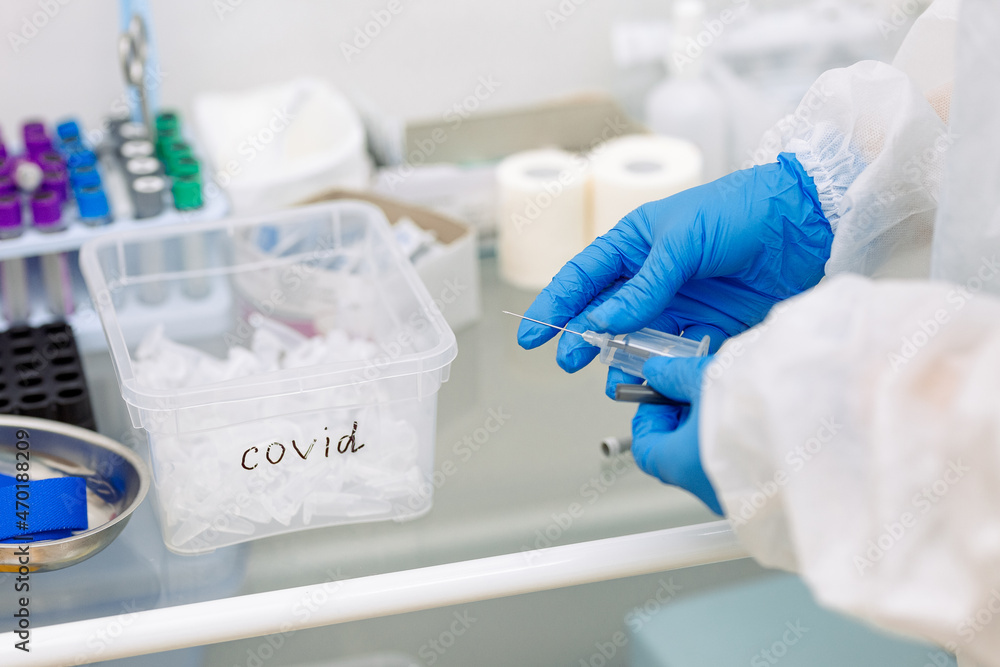 scientist working in laboratory in blue medical gloves doing a covid test scientist working in laboratory in blue medical gloves doing a covid test