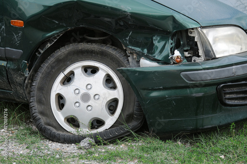 Part of wrecked green car