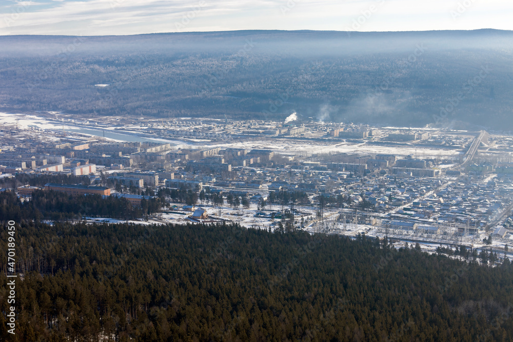 Siberian city of Ust-Kut on the Lena River among the taiga hills at the beginning of winter.