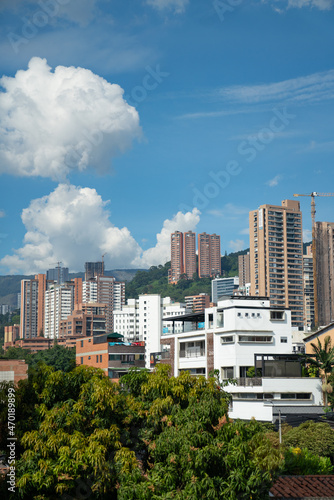 beautiful sunny day in poblado medellin showing many buildings in downtown