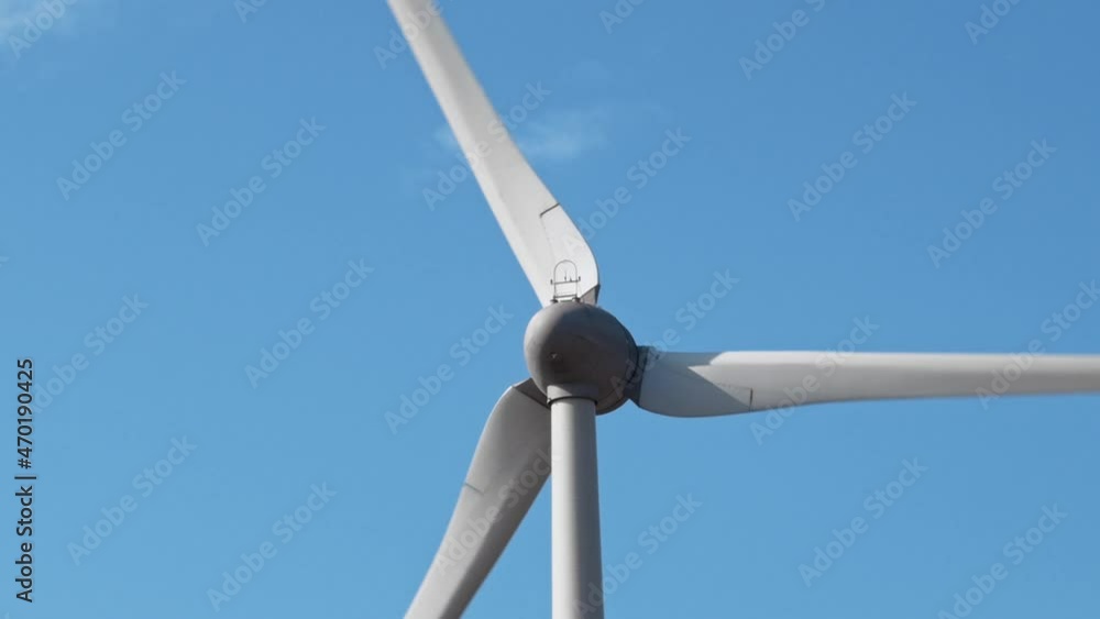 Close up of spining wind turbine with moving blades. Alternative, clean, and renewable energy sources. Closeup on turbine. Close up of spining wind turbine with moving blades. Alternative, clean, and renewable energy sources. Closeup on turbine.