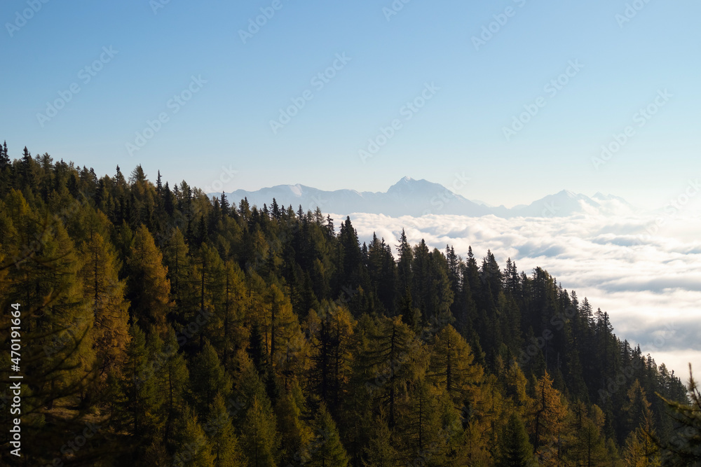 Sunrise on top of a mountain with view into misty valley with fog. Sunrise on top of a mountain with view into misty valley with fog.