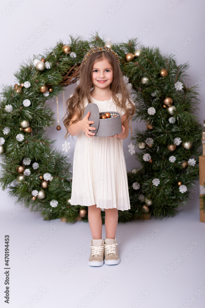 Cute little girl in a beautiful dress on Christmas.