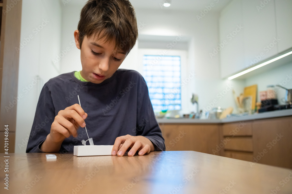 Child self testing for coronavirus at home before going to school. Child self testing for coronavirus at home before going to school.