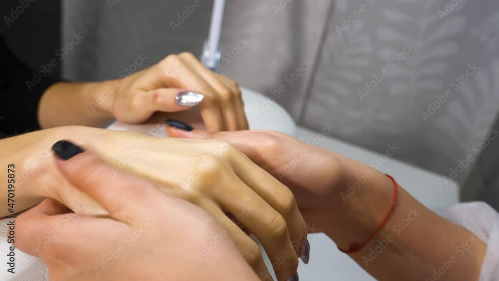 Girl getting fingers massage with scrub and oil in spa salon Girl getting fingers massage with scrub and oil in spa salon