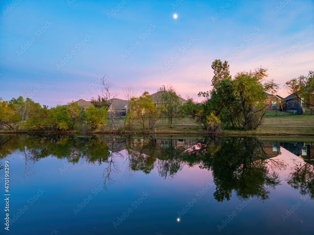 Sunset view of a community lake and residence