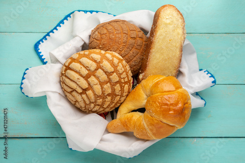 Basket with Mexican sweet breads on a turquoise background. photo