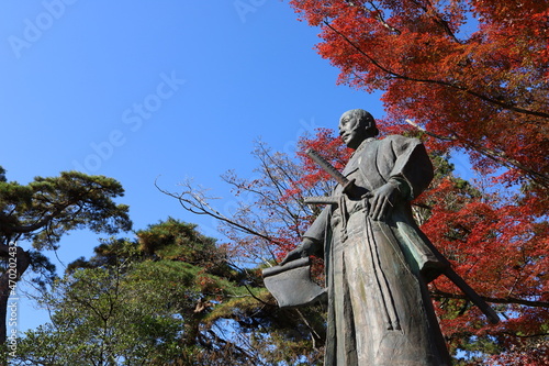 Sendai City, Miyagi Prefecture Japan, November 2021. A statue of Hasekura Tsunenaga at the site of Sendai Castle.Autumn leaves in Japan. photo