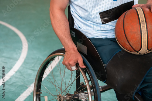 Close up photo of wheelchairs and handicapped war veterans playing basketball on the court © .shock