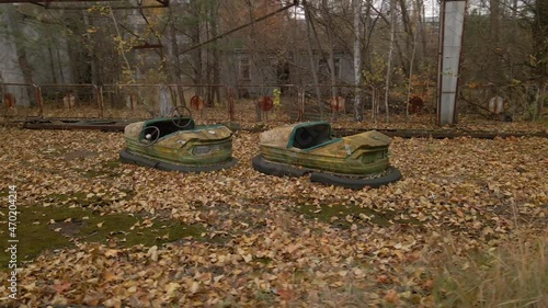 Decayed Autodrome with bumper cars in ghost town Pripyat in radioactive chernobyl exclusion zone photo