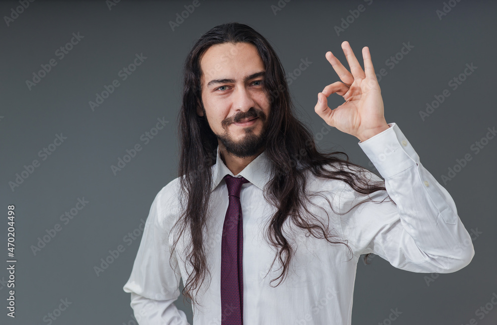 Handsome young Italian man is gesturing everything is okay and fine sign with his hands. Handsome young Italian man is gesturing everything is okay and fine sign with his hands.