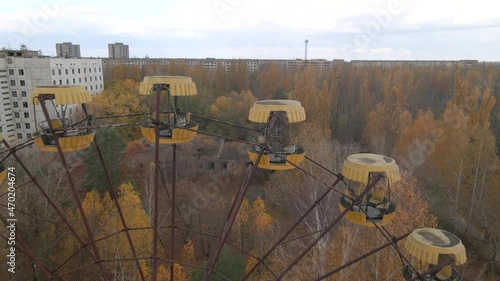 ADrone extremly close flyes near abandoned ferris wheel in Chernobyl Exclusion Zone. Pripyat, Ukraine. Aerial drone shot 4k photo