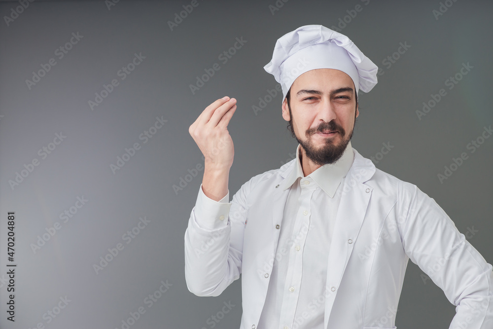 Amazed young male Italian handsome chef. He is Gesturing delicious sign, studio shot includes copy space. Amazed young male Italian handsome chef. He is Gesturing delicious sign, studio shot includes copy space.