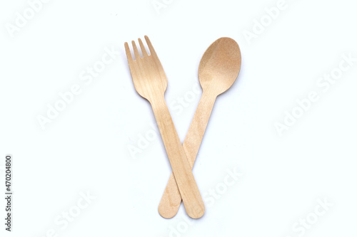 Wooden spoon and fork on white background.