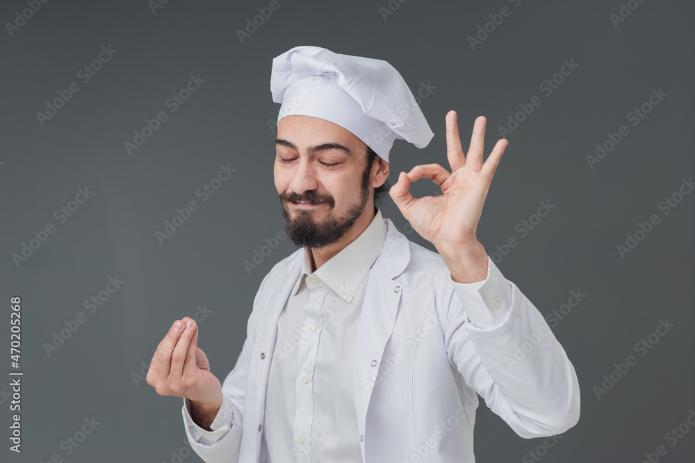 Amazed young male Italian handsome chef. He is Gesturing delicious sign, studio shot includes copy space. Amazed young male Italian handsome chef. He is Gesturing delicious sign, studio shot includes copy space.