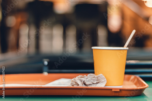 image of a yellow disposable coffee cup on a tray in a restaurant