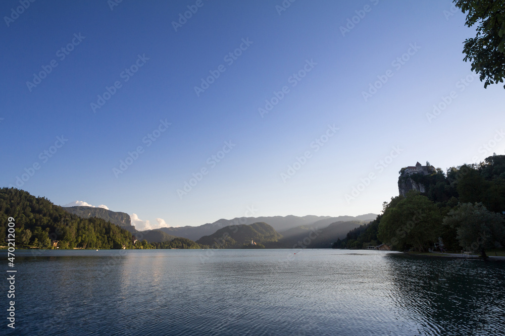 Fototapeta premium Selective blur on the Bled castle, also called Blejski Hrad, during summer, at sunset, by the mountains of Julian alps. Bled Castle is a major monument of Slovenia.......