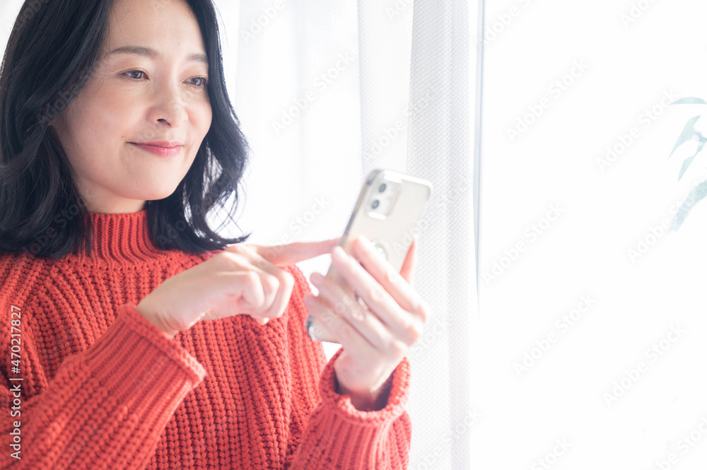 Beautiful Asian (Japanese) woman looking for something on her phone, copy space available, close up of face. Beautiful Asian (Japanese) woman looking for something on her phone, copy space available, close up of face.