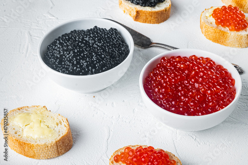 Bruschettes with butter red and black caviar, on white background