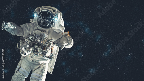 Fotografie, Obraz Astronaut spaceman do spacewalk while working for spaceflight mission at space station