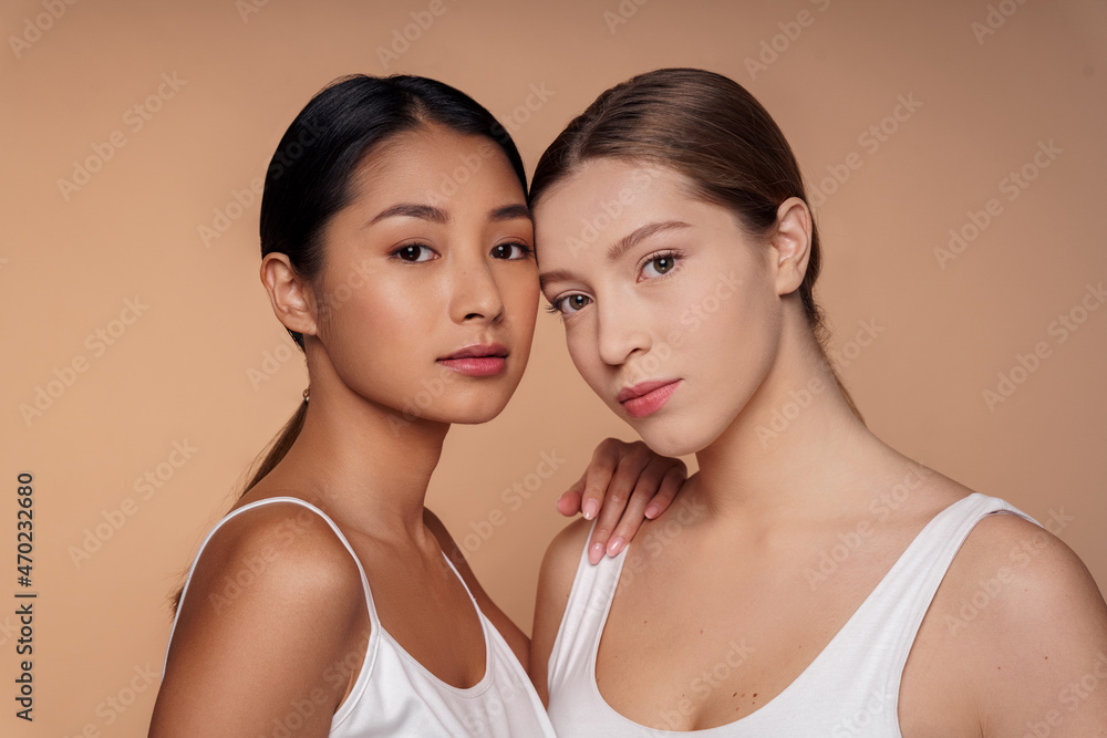Portrait headshot of young asian and caucasian beautiful woman looking at camera Portrait headshot of young asian and caucasian beautiful woman looking at camera