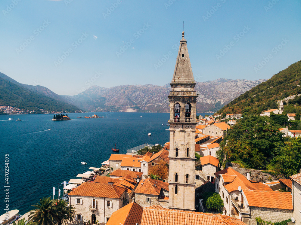 Drone view of the Perast coast with ancient houses and a bell tower. Montenegro