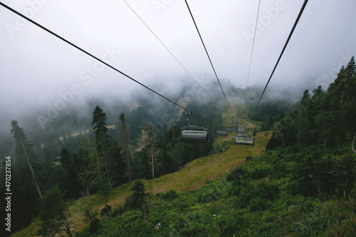 Majestic view of the beautiful misty mountains in a misty landscape. A dramatic unusual scene. Travel history. Exploring the world of beauty. The Caucasus Mountains. Russia. cable car without people