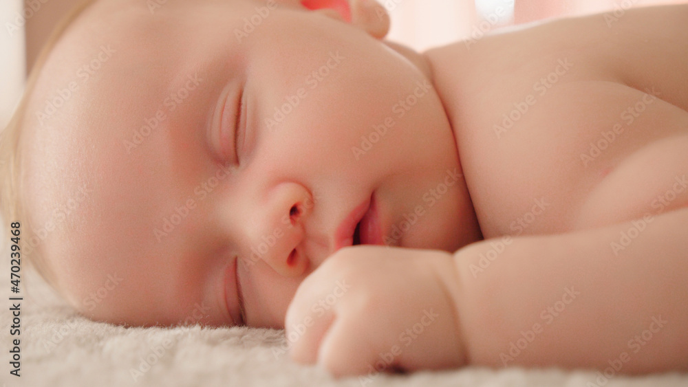 Healthy infant sleeping at home. Beautiful small baby sleeping. Close-up of infant sleeping. Macro shot of a small caucasian baby resting. Shot of napping child, afternoon nap. Healthy infant sleeping at home. Beautiful small baby sleeping. Close-up of infant sleeping. Macro shot of a small caucasian baby resting. Shot of napping child, afternoon nap.