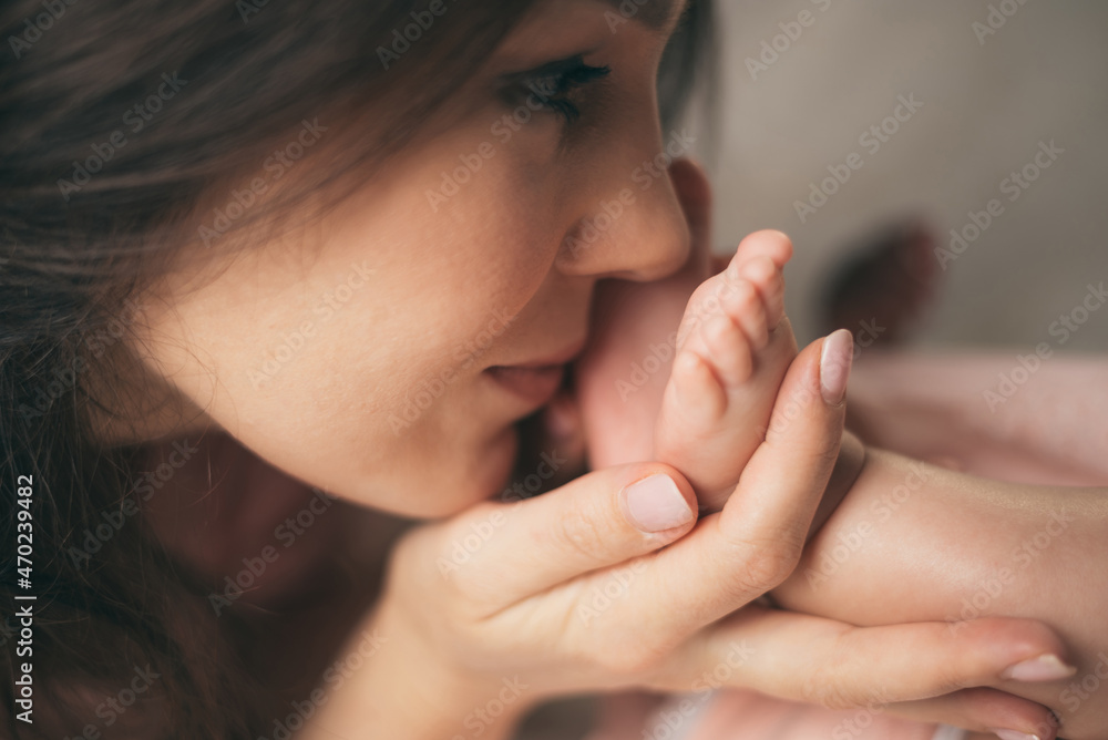 Beautiful mother kissing her little baby daughter Beautiful mother kissing her little baby daughter